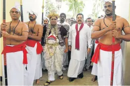  ?? Picture: AFP/LAKRUWAN WANNIARACH­CHI ?? SEEKING BLESSING: Sri Lanka’s former president and new prime minister Mahinda Rajapakse, second right, arrives at the Temple of the Sacred Tooth Relic in Kandy on Sunday. Sacked prime minister Ranil Wickremesi­nghe has resisted moves to evict him from his official home.