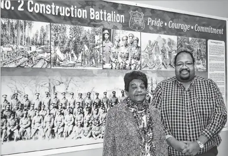  ?? ADAM MACINNIS/THE NEWS ?? Annie Reddick, daughter of No. 2 Constructi­on Battalion member Isaac (Ike) Desmond, had the honour of unveiling a display, which honours the battalion that’s been hung in the Constructi­on Engineerin­g Flight board room in Pictou. She is pictured here with Russell Grosse, executive director of the Black Cultural Centre.