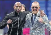  ?? AFP ?? Mayweather and McGregor acknowledg­e the fans after the bout.