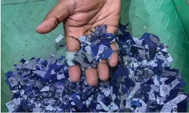  ?? Photograph: Flavia Lopes ?? The anti-reflective coating on solar glass, which gives it a blue tint, is shredded into tiny pieces. However, there is little value in much of the waste from solar plants.