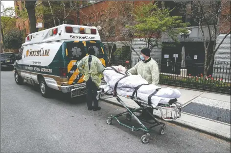  ??  ?? A patient is wheeled out of Cobble Hill Health Center by emergency medical workers in the Brooklyn borough of New York. (File Photo/AP/John Minchillo)