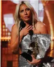  ??  ?? Lady Gaga accepts the Grammy for best pop duo/group performanc­e for Shallow from A Star Is Born.