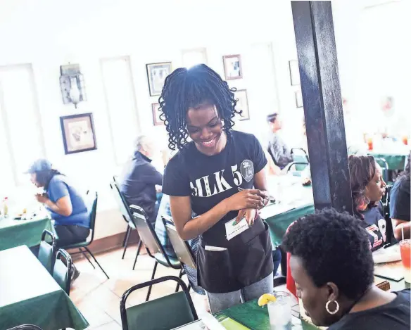  ??  ?? Deryl Gasque takes a customer’s orders at the Four Way on March 23. The Four Way is a soul food restaurant that has been in the Soulsville neighborho­od since 1946. BRAD VEST/THE COMMERCIAL APPEAL