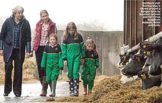  ??  ?? Northern visit: Theresa May is shown around a Bangor farm by Susanne Jackson and her three daughters Hannah, Abbie and Emily