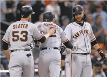  ?? Orlando Ramirez / Associated Press ?? Chase d’Arnaud (center) is congratula­ted after his three-run homer in the second inning gave the Giants the lead.