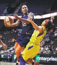  ?? Jessica Hill / Associated Press ?? Alyssa Thomas, left, of the Connecticu­t Sun drives to the basket against Allisha Gray of the Dallas Wings during a preseason WNBA game May 8 in Uncasville.