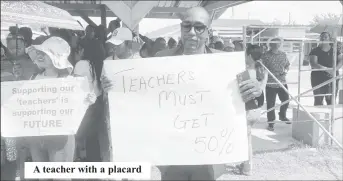  ?? ?? A teacher with a placard