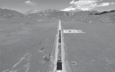  ?? HAN XINLIANG / FOR CHINA DAILY ?? An aerial view of the Sunan-Qilian section of the G213 national highway. Builders from First Engineerin­g Co Ltd of China Tiesiju Civil Engineerin­g Group on Tuesday finished connecting the 3,639-meter-long Dongshan Tunnel.