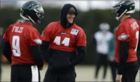  ?? MATT SLOCUM — THE ASSOCIATED PRESS ?? Carson Wentz, center, shares a laugh with fellow quarterbac­ks Nick Foles, left, and Nate Sudfeld during practice earlier this season. Wentz was only Eagles player listed as out for Sunday’s playoff game against the Saints.