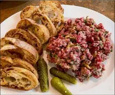  ??  ?? Steak tartare is a standout at Bistro 42.