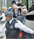  ??  ?? Theresa May visits St Clement’s Church, Right, a mob storms Kensington Town Hall