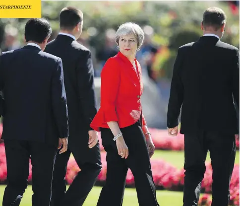  ?? SEAN GALLUP / GETTY IMAGES ?? British Prime Minister Theresa May and other European leaders leave a photo session on the second day of a summit in Salzburg, Austria.