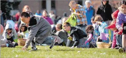  ?? ?? Far left, children scramble for Easter eggs during the 2022 City of Groton Easter Egg Hunt.