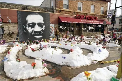  ?? JIM MONE — THE ASSOCIATED PRESS ?? George Floyd Square is shown on Feb. 8, 2021, in Minneapoli­s. Ten months after police officers brushed off George Floyd’s moans for help on the street outside a south Minneapoli­s grocery, the square remains a makeshift memorial for Floyd who died at the hand of police making an arrest. The trial of former Minneapoli­s police officer Derek Chauvin will begin with jury selection on March 8.