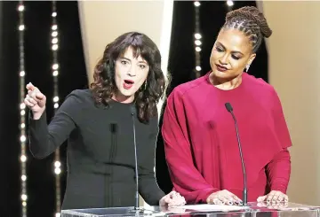  ??  ?? Asia Argento (left) delivers a speech next to Jury member Ava DuVernay at the closing ceremony of the Cannes Film Festival Saturday.