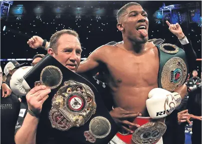  ?? Picture: Getty Images. ?? World heavyweigh­t champion Anthony Joshua with his haul of belts.
