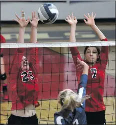  ?? Jayne Kamin-Oncea/For The Signal ?? (Above) Megan Dombrowski, left, and Alicia Castillo, right, reach for a block a on Tuesday. (Left) Cora Machado spikes the ball over Trinity defenders.