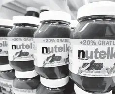  ??  ?? Jars of Nutella are seen at a local supermarke­t in France. For best practices in sustainabl­e palm oil and low contaminan­ts in palm oil, Ferrero pays a premium of 130 euros per tonne, which sums up to an additional 25 million euros annually. — Reuters...