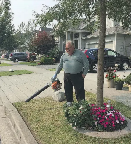  ?? JENNIFER SALTMAN ?? Benjamin Tumak does yard work in front of his house Wednesday after a shooting on 180th Street Tuesday in Surrey. He said he was surprised to hear of the incident in a nearby complex.