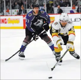  ?? David Zalubowski ?? Golden Knights right wing Alex Tuch reaches out for a loose puck Saturday in Denver as Avalanche left wing J.T. Compher skates in. The Associated Press