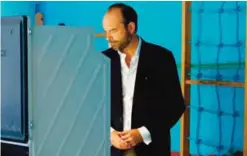  ??  ?? LE HAVRE: French Prime Minister Edouard Philippe casts his electronic vote at a polling station during the first round of legislativ­e elections on June 11. — AFP