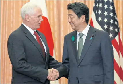  ?? BLOOMBERG ?? US Vice-President Mike Pence shakes hands with Shinzo Abe, Japan’s prime minister, during their meeting at Mr Abe’s official residence in Tokyo, Japan, yesterday.