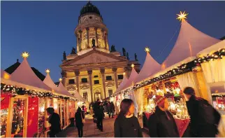  ?? SEAN GALLUP/GETTY IMAGES FILES ?? Visitors walk through a Christmas market in Berlin in 2011. St. John’s Lutheran Church will hold a traditiona­l German Christmas market on Dec. 1 and 2 at 3594 Jeanne-Mance St.