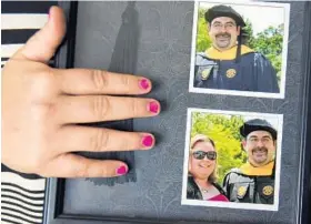  ??  ?? Heather Owens holds framed photos of herself and her boyfriend, Joe Blevins, at his graduation from the University of Maryland University College.