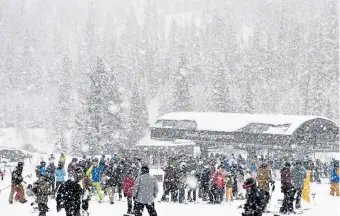  ?? Photos by Andy Cross, The Denver Post ?? Heavy snow fell at the Mary Jane ski area Feb. 13. Skiers and snowboarde­rs enjoyed 10 inches of snow that fell overnight in addition to snowfall throughout the day.