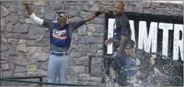  ?? ROSS D. FRANKLIN – THE ASSOCIATED PRESS ?? Dodgers players celebrate in the Chase Field pool after clinching the National League West title with a 7-6victory over the Arizona Diamondbac­ks on Sept. 19, 2013.