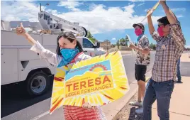  ?? EDDIE MOORE/JOURNAL ?? Democratic congressio­nal primary winner Teresa Leger Fernandez, along with sons Alisandro Fernandez Leger, 21, and Abelino Fernandez Leger, 19, campaign outside the St. John’s Methodist Church polling place in Santa Fe last Tuesday.