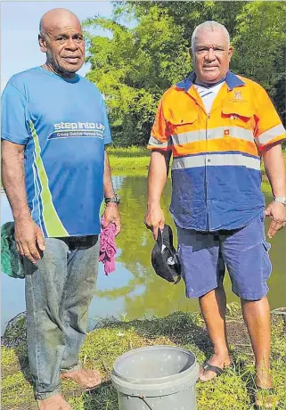  ?? Pictures: MINISTRY OF FISHERIES ?? Nairukuruk­u villager Josua Qaduadua, 64, (left) with Minister for Fisheries and Forestry Kalaveti Ravu in Naitasiri last week.