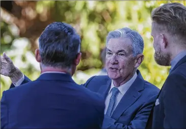  ?? AMBER BAESLER/ASSOCIATED PRESS ?? Federal Reserve Chair Jerome Powell takes a coffee break with attendees of the central bank’s annual symposium Friday at Jackson Lake Lodge in Grand Teton National Park in Moran, Wyo.