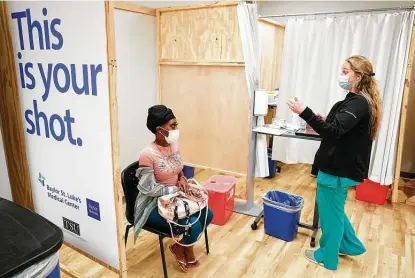  ?? Photos by Melissa Phillip / Staff photograph­er ?? Demetria Caston awaits a Pfizer COVID-19 vaccinatio­n from registered nurse Kayla Shepherd at the St. Luke’s Health walk-in vaccinatio­n clinic at Texas Southern University in Houston on Monday. St. Luke’s could offer a second such clinic next week.