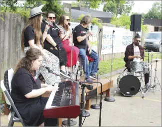  ?? Katie West • Times-Herald ?? Heather Roberts, left, Jana Calvert, Haley Busby, Jamie Andrews, Mike Vickers and Jacob Brazile with ConnectPoi­nt Church share music during the first Forrest City Farmers Market of the season, held Saturday at the Civic center. The stage was built by East Arkansas Community College. The market is always looking for groups, duos or solos to perform during market hours each Saturday. For more informatio­n, message the Forrest City Farmers Market’s Facebook page.