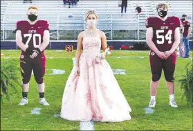  ??  ?? Senior maid Taylor Norman was escorted by Isaiah Freeman and Jerry Harris.