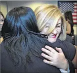  ??  ?? Regina Pritchard receives a hug after the award ceremony on Wednesday. The mother of three says, “It means a lot to be honored. I didn’t really think it would, though, it’s just what you do every day.”