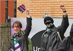  ?? ?? ... and raise the red flag: Lecturers and students man the picket lines in show of defiance outside Manchester University yesterday