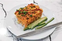  ?? ?? Alissa Nguyen’s viral sushi bake recipe is made with imitation crab, salmon, cream cheese, rice, seaweed and sriracha.