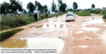  ?? ?? A motorist weaves his way through an undevelope­d road in Solomio, a new suburb in Ruwa, recently. —Picture: Innocent Makawa