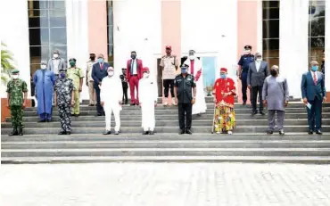  ??  ?? Governor Okowa (centre, on white) with the inaugurate­d members of the State Community Policing Advisory Committee (SCPAC.