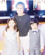  ??  ?? Milagros Cruz with grandchild­ren Princess Synne and Prince Sean Cruz.