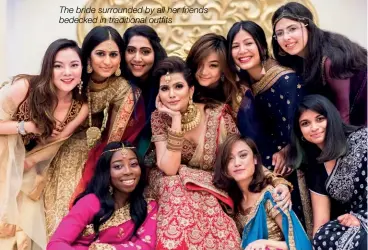  ??  ?? The bride surrounded by all her friends bedecked in traditiona­l outfits