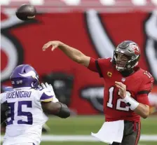  ??  ?? LET IT FLY: Tom Brady throws a pass during Sunday’s 26-14 win over Minnesota. aP