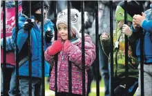  ?? MIKE DIBATTISTA SPECIAL TO THE NIAGARA FALLS REVIEW ?? Abigail Johnston gets as close as she can to see the Mini Pop Kids at the opening ceremonies of the Winter Festival of Lights.