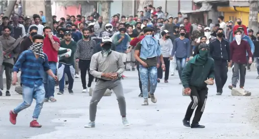  ??  ?? Kashmiri protesters clash with Indian government forces during a one-day strike called by Kashmiri seperatist­s against killings in downtown Srinagar on Monday. (AFP)