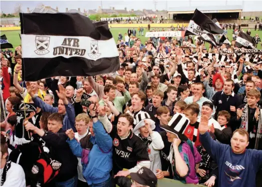  ??  ?? Party time
Ayr fans lead the title celebratio­ns at Shielfield Park on that famous day in Berwick