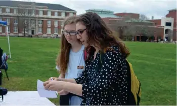  ?? Benton, SDN) (Photo by Charlie ?? MSU Students for Life Vice President Isabelle Comfort, left, and member Hannah Loper, right, hand out leaflets for a March 6 lecture from pro-life activist Christina Marie Bennett Wednesday. The Bennett lecture was scheduled in response to a lecture...