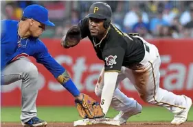  ?? Matt Freed/Post-Gazette ?? Starling Marte steals second base ahead of the tag from Cubs shortstop Javier Baez in the fourth inning Friday at PNC Park.