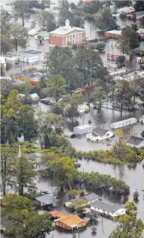  ?? AP PHOTO/STEVE HELBER ?? Floodwater­s from Hurricane Florence inundate the town of Trenton, NC., on Sunday.